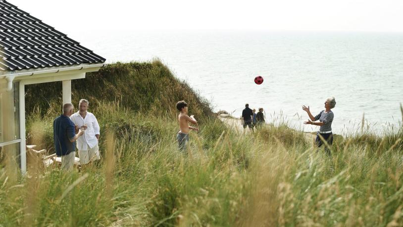 Family playing in summer house near beach, West Jutland