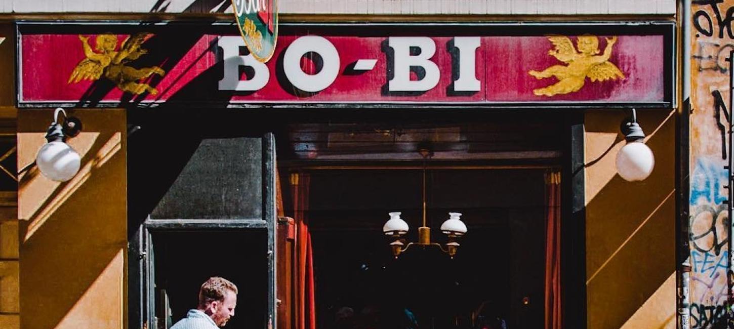 A couple chat outside the bodega Bo Bi in Copenhagen, Denmark - a Danish version of a local pub