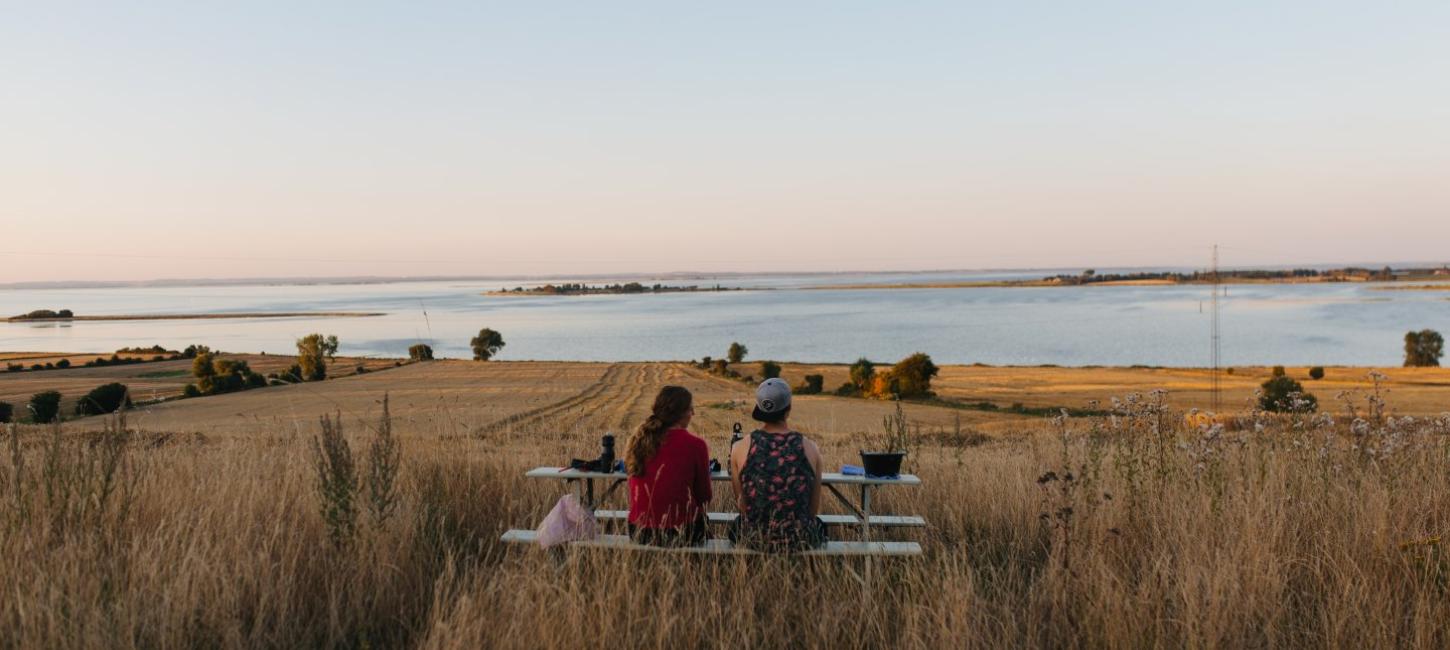 Friends with bikes overlooking the water on the island of Ærø, Denmark