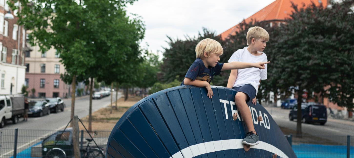 Two kids playing on a playground