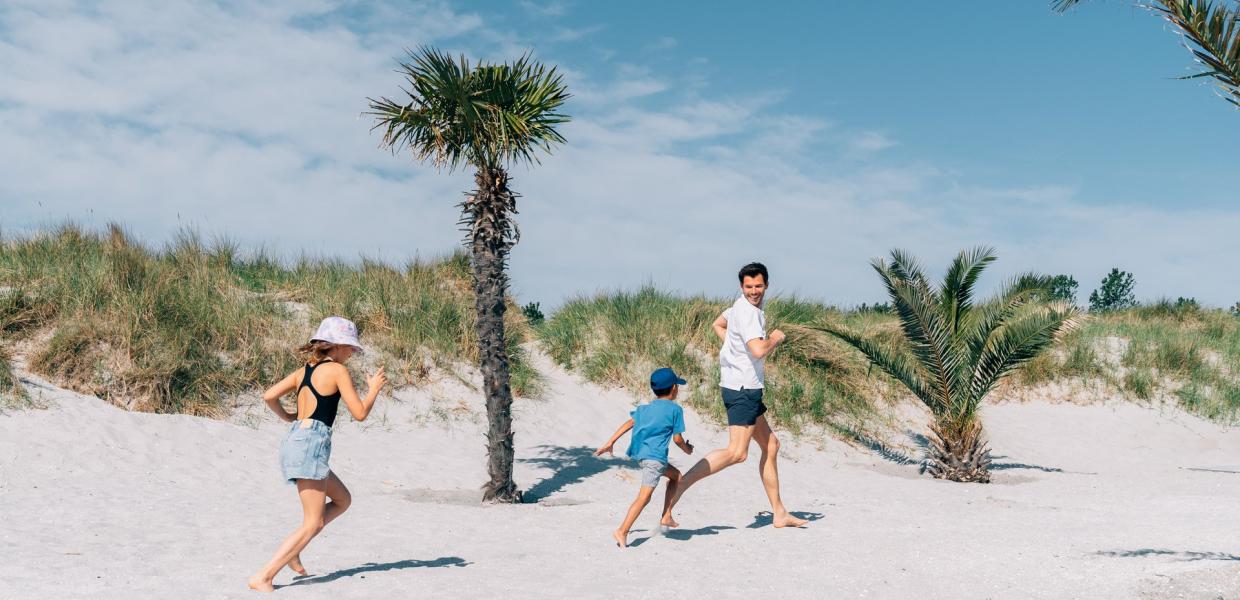 Family running on the Palm Beach in the Danish Frederikshavn, North Jutland 