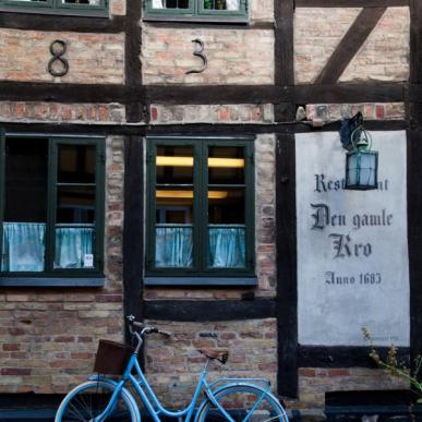 A bike leans against the wall of Den Gamle Kro, a pub in Odense, Denmark