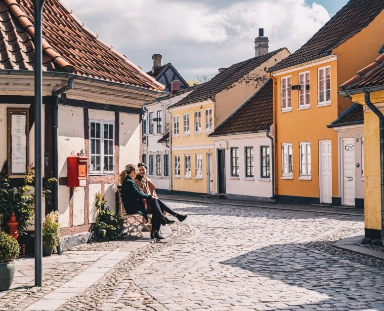 Women sitting on a bench in old town of Odense on Fyn